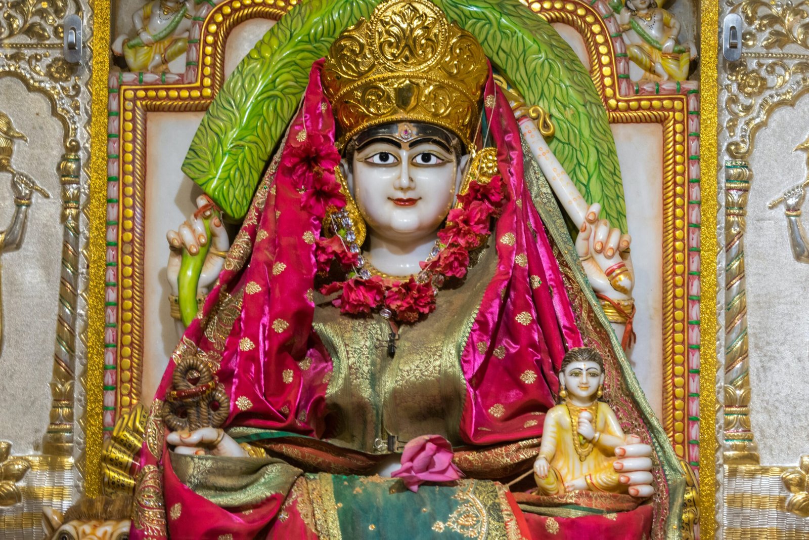 a statue of a woman in a red and gold outfit